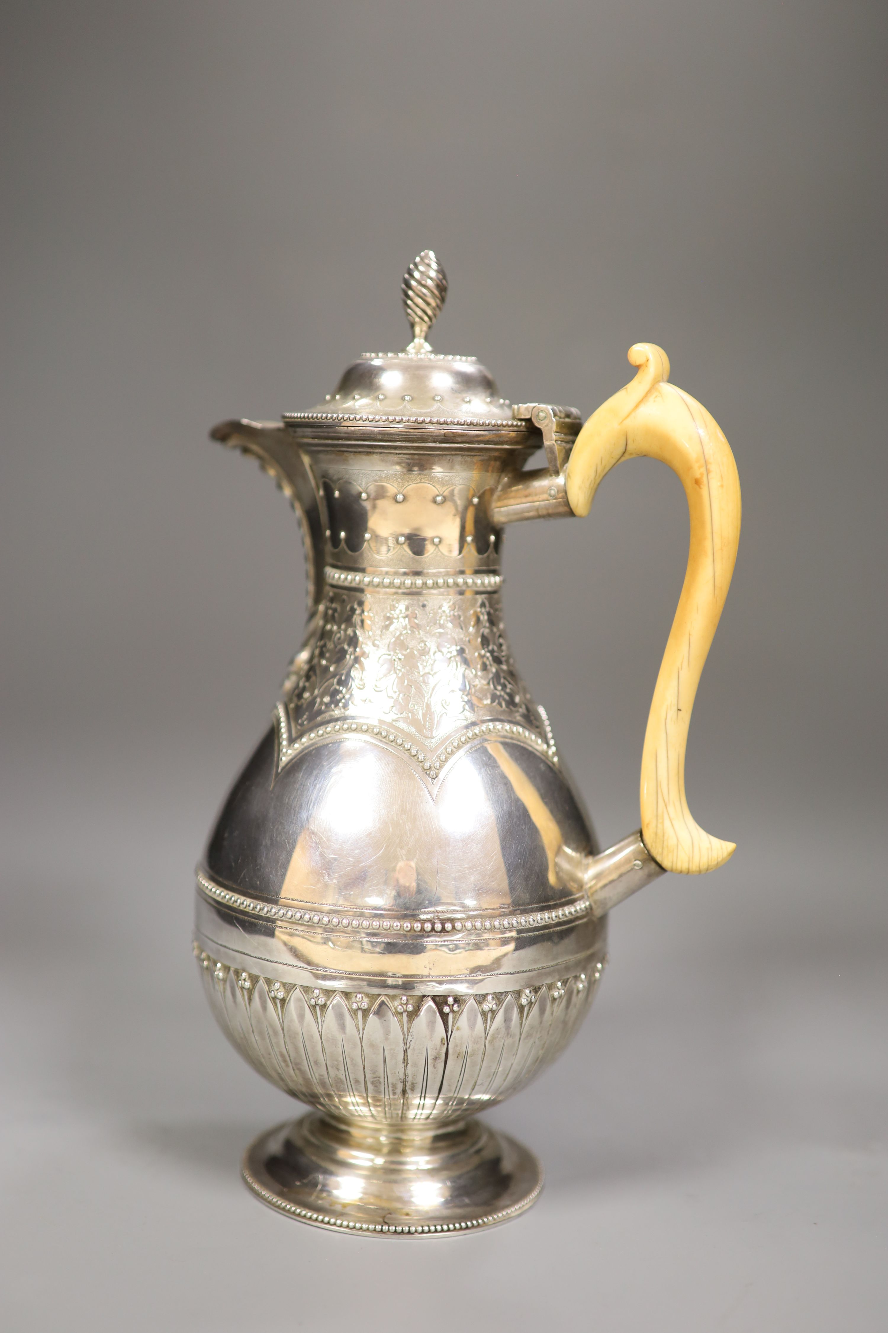 A Victorian silver baluster hot water pot, Henry Holland, London, 1878, with ivory handle, height 23.8cm, gross 15oz.